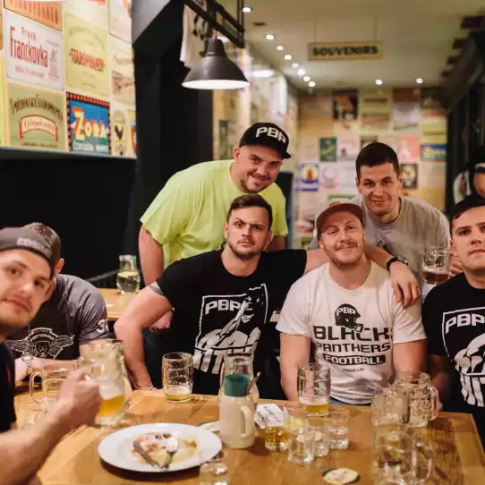 Group of guys enjoying drinks and a great meal during pub crawl.