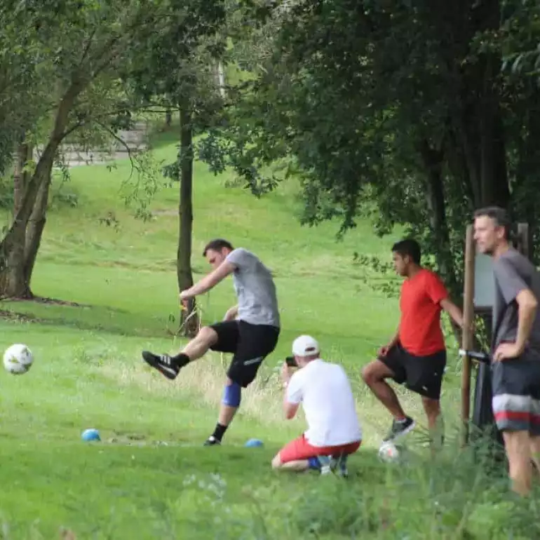 Group of people playing foot golf on a course in Prague.