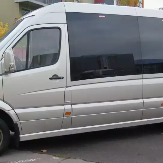 Silver van waiting for customers during an airport pick up.