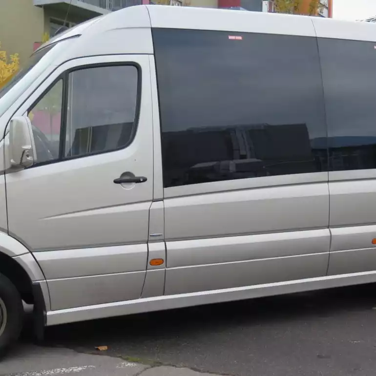 Private airport transfer shuttle waiting in front of an airport in Budapest.