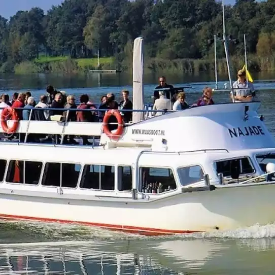 Large boat with many people cruising the Vltava river