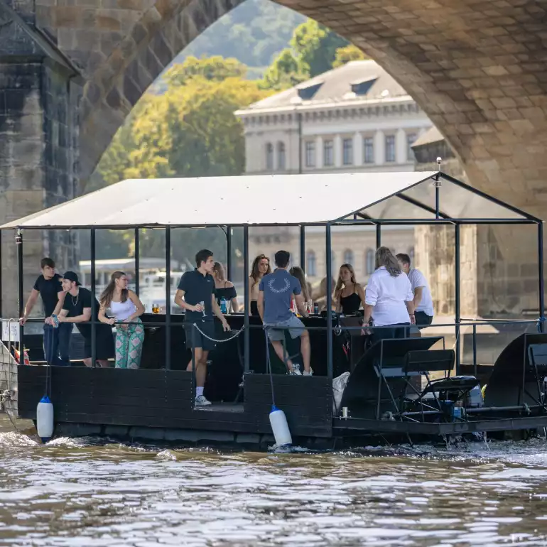 Beer boat captains enjoying a ride on Vltava river.