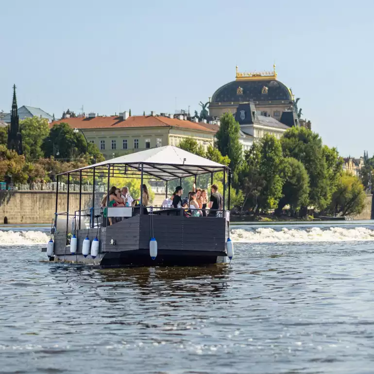 Group of people drinking beer on a beer boat in Prague.