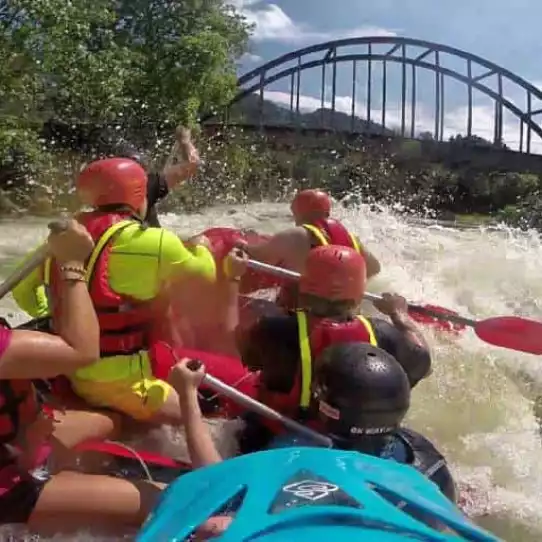 Group enjoying whitewater rafting during their bachelor party in Prague.