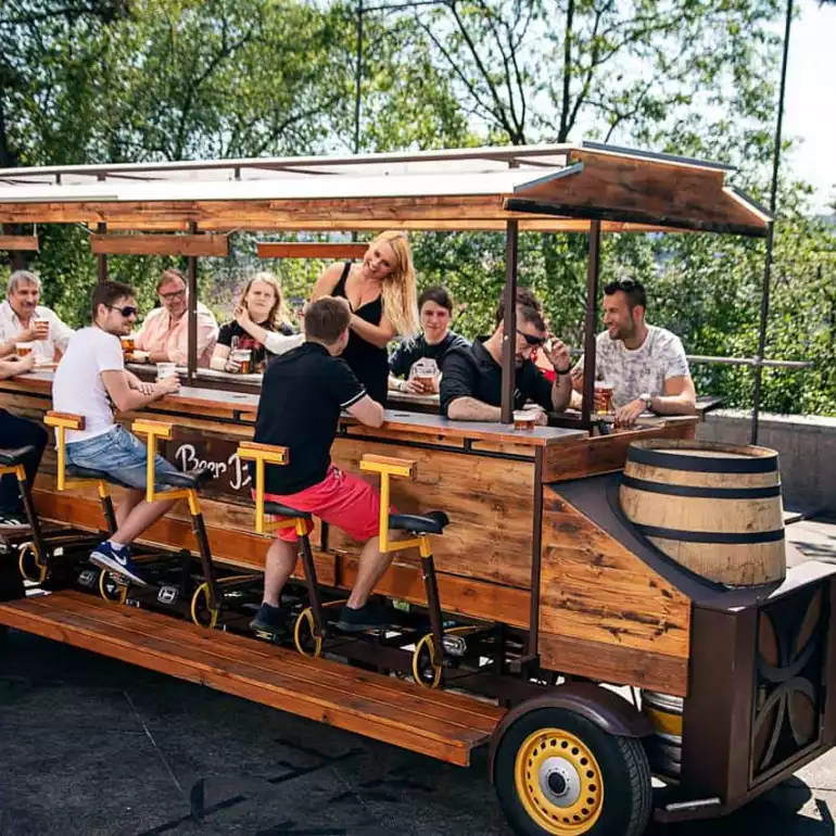 Bachelor party group riding a beer bike in Prague.