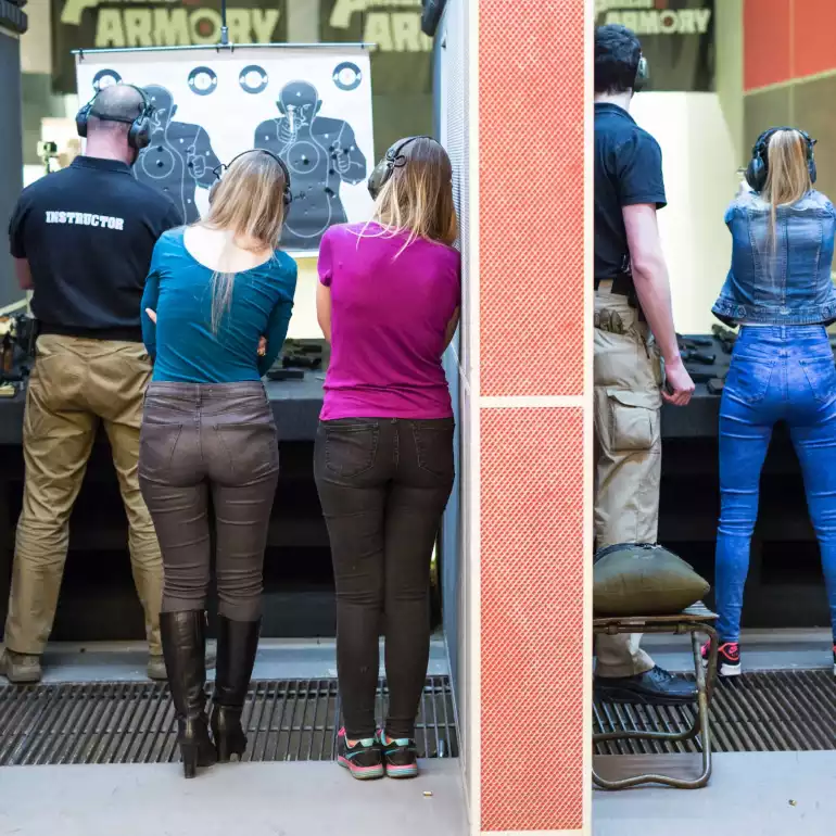 Group of ladies shooting at a target at a gun range in Prague.