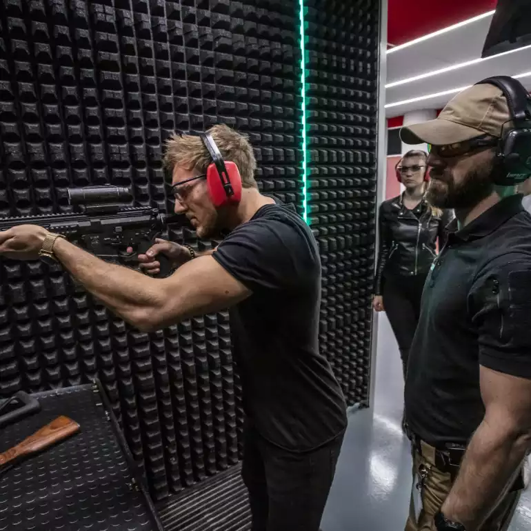 Person trying a riffle at a gun range in Prague.