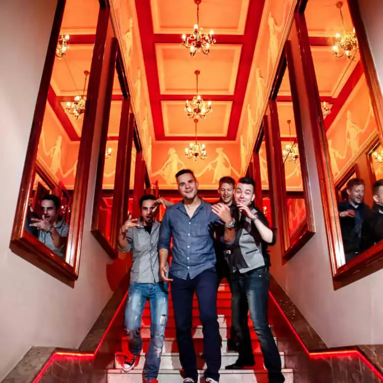 Group of guys walking down the stairs to a popular Warsaw club.