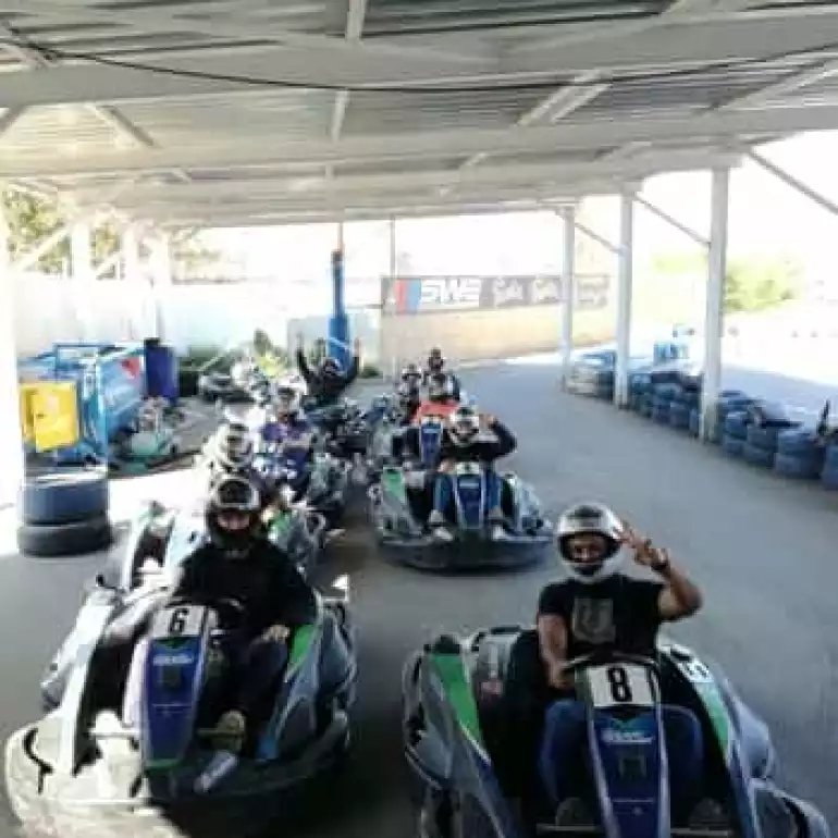 Group of friends enjoying a go kart track.