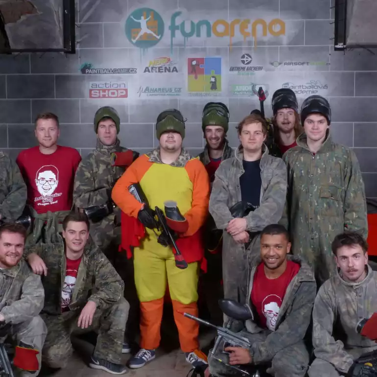 Bachelor party group before a paintball game in an indoor arena.