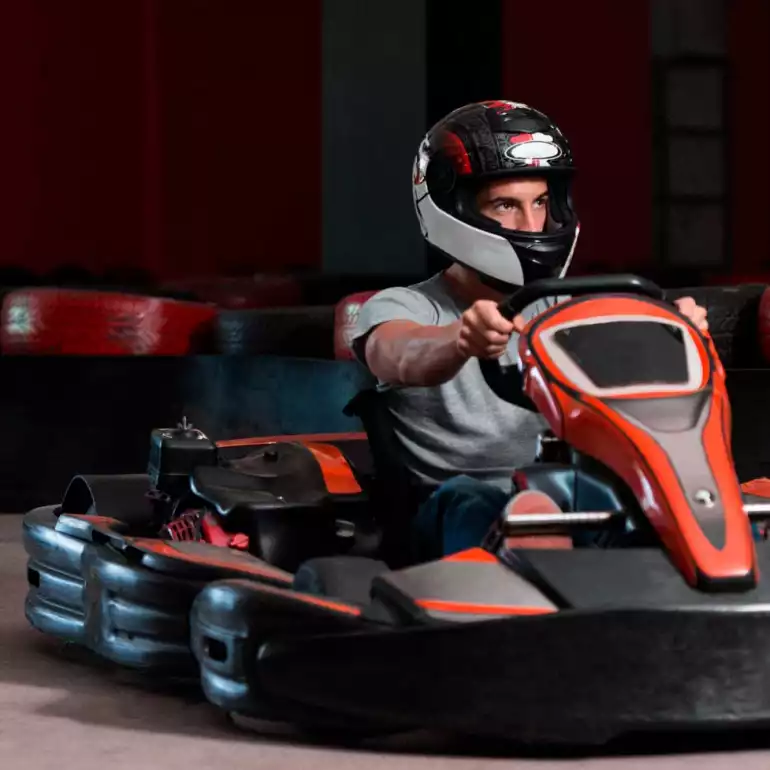 A guy participating in a go kart race in Prague.