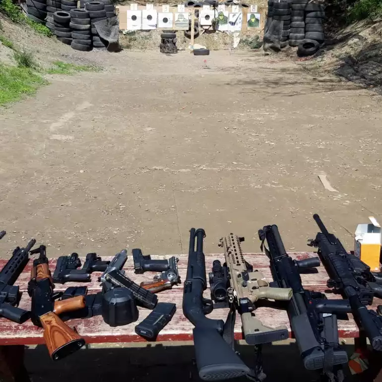 Multiple weapons prepared for a gun range experience at a Warsaw gun range.