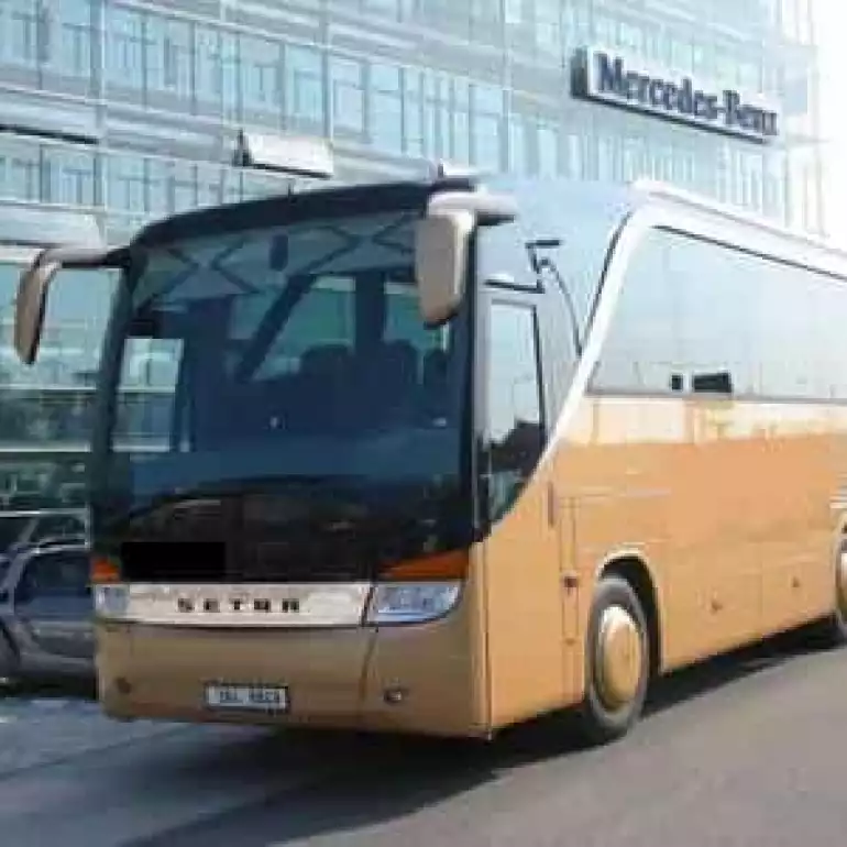 Bus waiting for large group of customers by Prague airport.