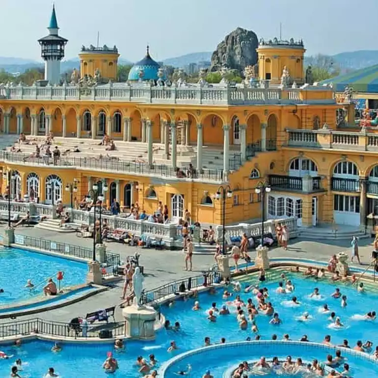 Beautiful view of the blue water and historic colorful buildings at Budapest's Széchenyi Spa.